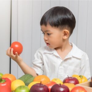 Little boy holding vegetable